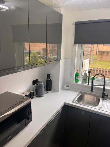 a kitchen with a sink and a window at Hutchison apartments in Edinburgh