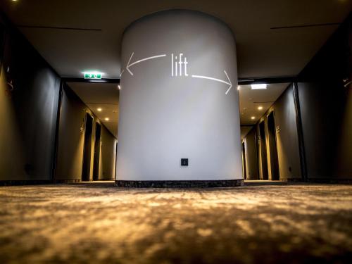 a room with a white wall with aigunigun at ibis Wels in Wels