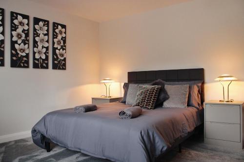 a bedroom with a bed with two night stands and two lamps at Luxury Bungalow Countryside view in Aughton