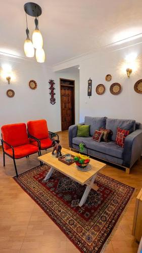 a living room with a couch and a table at Cozy Safari in Entebbe