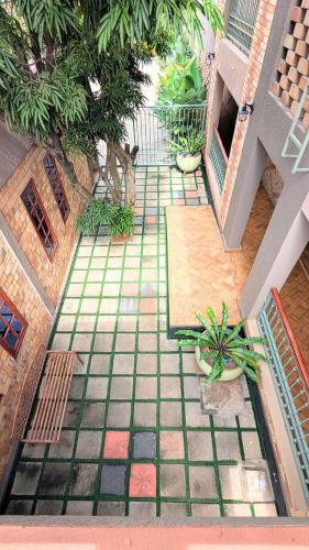 an outdoor patio with a tile floor and plants at Cozy Safari in Entebbe