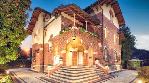 a large brick building with stairs in front at Villibera - Design villa with SPA, Cinema, Gym and Game Room in Cesano Maderno