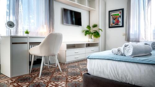 a bedroom with a desk and a bed with a chair at Villibera - Design villa with SPA, Cinema, Gym and Game Room in Cesano Maderno