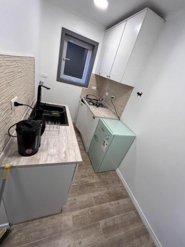 a kitchen with a sink and a refrigerator at Patagonia Stay in Puerto Natales