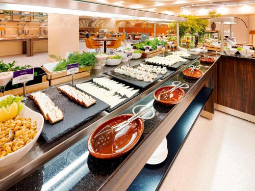 a buffet line with food on display in a restaurant at Mercure Istanbul Bakirkoy in Istanbul