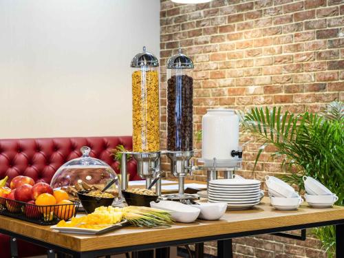a wooden table with food on top of it at ibis Styles Lublin Stare Miasto in Lublin