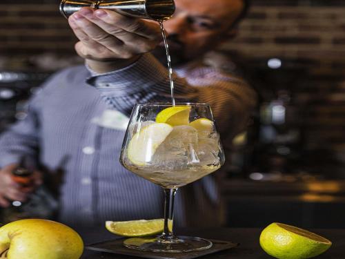 a man pouring a drink into a wine glass at ibis Styles Lublin Stare Miasto in Lublin
