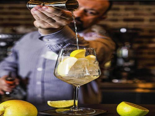 a man pouring a drink into a wine glass at ibis Styles Lublin Stare Miasto in Lublin