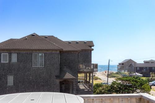 a large brick house with a view of the ocean at 8076 - Siren's Serenade in Rodanthe