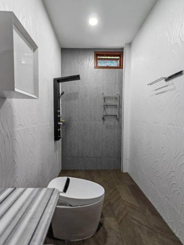 a bathroom with a white toilet and a shower at Windy Pool Villa Pattaya Private Entire house in Ban Bang Lamung