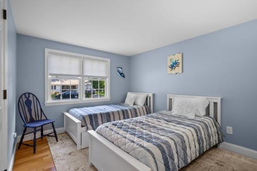 a bedroom with two beds and a window at 111 Eileen Street Yarmouth Port - Starfish Escape in Yarmouth