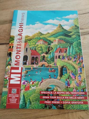 a book on the cover of a puzzle of a mountain village at un balcone sul lago in Omegna
