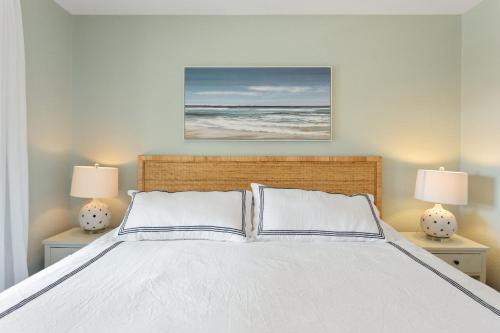 a bedroom with a white bed with two lamps at 8076 - Siren's Serenade in Rodanthe