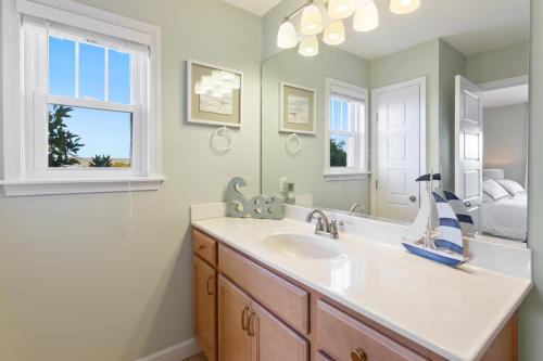 a bathroom with a sink and a mirror at 8076 - Siren's Serenade in Rodanthe