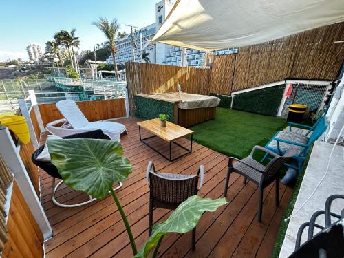 a deck with chairs and a table on a boat at דופלקס כנרת in Tiberias