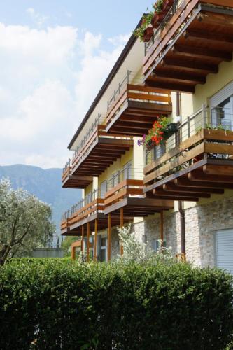a building with balconies and flowers on it at Residence Rivachiara (check-in at Hotel Riviera in Viale Rovereto, 95) in Riva del Garda