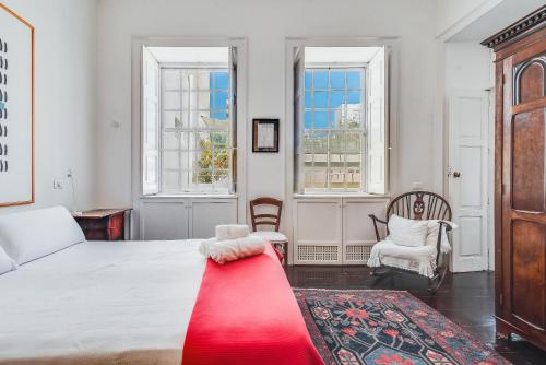 a bedroom with a bed with a red blanket on it at Santa Barbara Vegueta in Triana