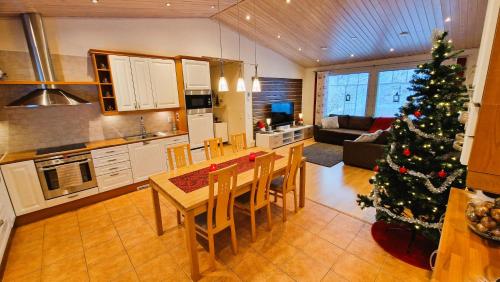 a kitchen and living room with a christmas tree in it at House at the Arctic Circle- next to Santa Claus in Rovaniemi