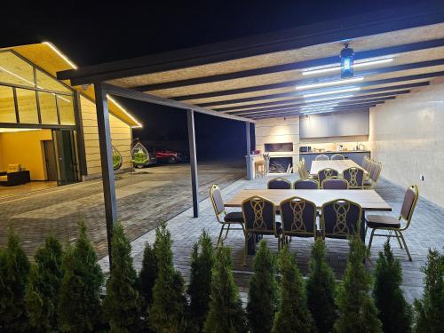 a dining table and chairs in a garage at night at Arev Rest House in Katʼnaghbyur