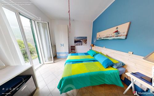 a bedroom with a bed and a blue wall at Ai Cinque Campanili in Finale Ligure