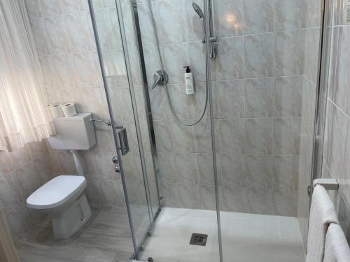 a bathroom with a shower and a toilet at Hotel Villa Luisa in Lignano Sabbiadoro