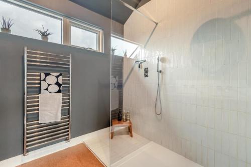 a bathroom with a shower with a glass door at 3 Bed in Milford On Sea oc-f33344 in Milford on Sea