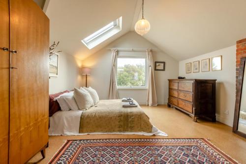 a bedroom with a bed and a dresser and a window at 3 Bed in Milford On Sea oc-f33344 in Milford on Sea