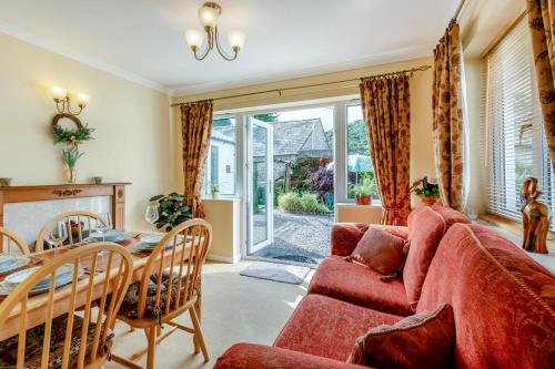 a living room with a red couch and a table at 2 Bed in Pooley Bridge oc-c33318 in Pooley Bridge