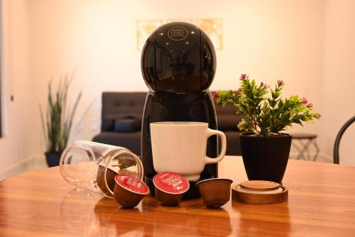 a black coffee maker sitting on top of a table at Hotel 28 Cancun in Cancún