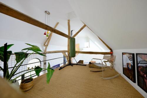 a attic room with a large window and plants at Magnifique maison d'architecte pour 8 pers avec piscine privée in Roncherolles