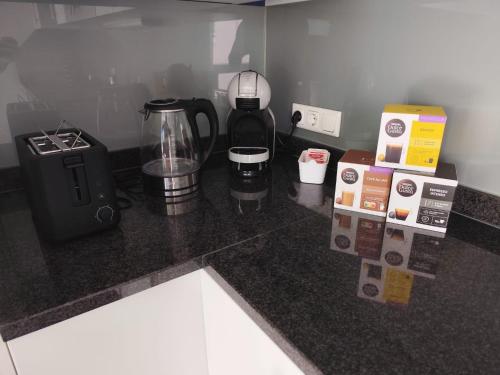 a kitchen counter with a coffee maker and a blender at Bella Vista Ferienwohnung in Bürs