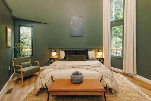 a bedroom with a large bed and a table at NEW Unique Stay w King Beds and Private Hot Tub in Rogers