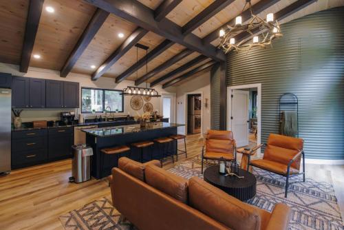 a kitchen and living room with a couch and chairs at NEW Unique Stay w King Beds and Private Hot Tub in Rogers