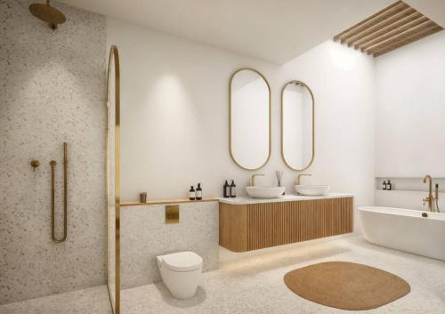 a bathroom with two sinks and a tub and two mirrors at Modern 3BR Villa, Rooftop Dining and Fast WiFi in Pererenan