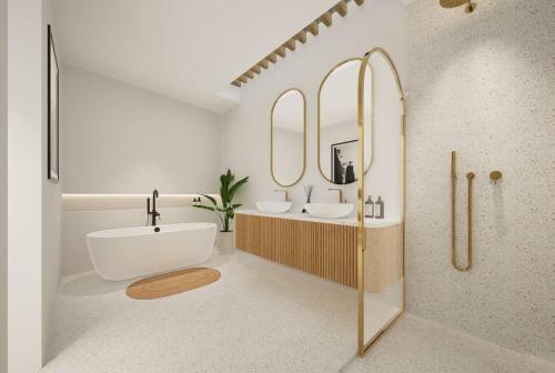 a bathroom with two sinks and two mirrors at Stylish 3BR Villa - Walk to Pererenan Beach in Pererenan