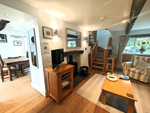 a living room with a television and a table at 2 Bed in Troutbeck oc-c33392 in Troutbeck