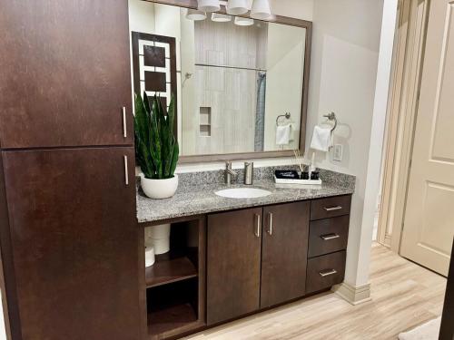 a bathroom with a sink and a large mirror at Peaceful Luxury Getaway in Dallas TX in Addison