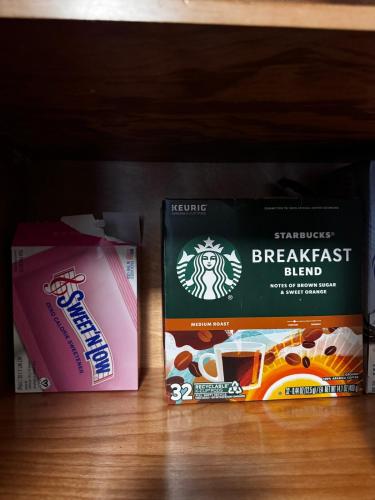 two bags of breakfast blend and a box of food on a shelf at Peaceful Luxury Getaway in Dallas TX in Addison
