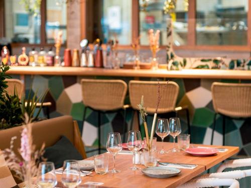 a table with wine glasses on it in a restaurant at Novotel Paris Porte Versailles in Paris