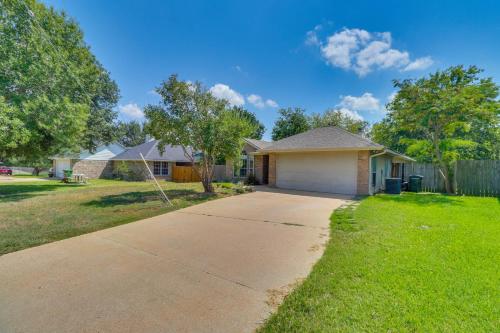 a house with a driveway in a yard at Tailgate Fun and Campus Spirit Bryan Home with Patio in Bryan