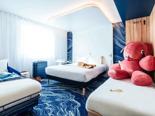 a room with two beds with red stuffed animals on them at ibis Styles Paris Orly Airport in Paray-Vieille-Poste