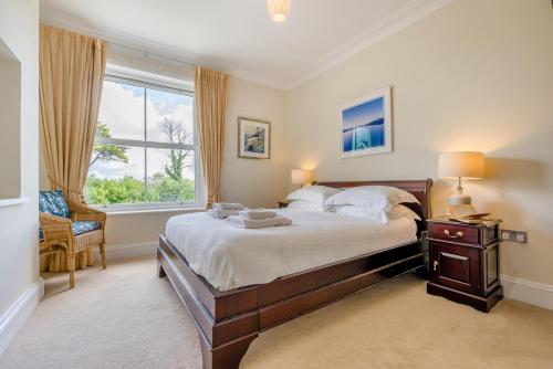 a bedroom with a large bed and a window at 3 Bed in Fowey oc-o33078 in Fowey