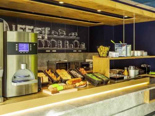 a bakery counter with various types of bread and pastries at Ibis Budget Montpellier Nord Euromédecine in Montpellier