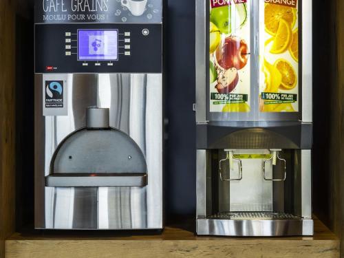 a coffee machine next to a box of food at Ibis Budget Montpellier Nord Euromédecine in Montpellier