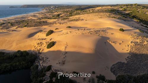 an aerial view of a beach with sand and water at Il terrazzo sulla duna 4 Torre dei Corsari in Torre Dei Corsari