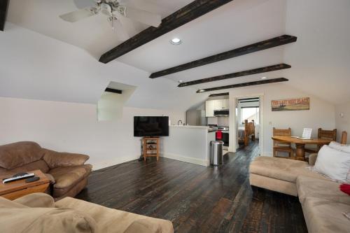 a living room with two couches and a tv at Cabin on Horse, Donkey and Cow Farm in Bozeman