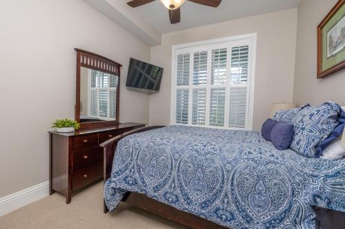 a bedroom with a bed and a dresser and a mirror at Marina Retreat in Saint Simons Island