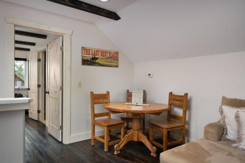 a room with a table and chairs and a couch at Cabin on Horse, Donkey and Cow Farm in Bozeman
