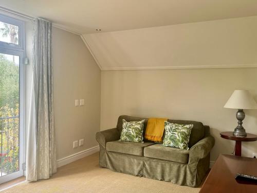 a living room with a couch and a window at Wild Mushroom Country House in Stellenbosch