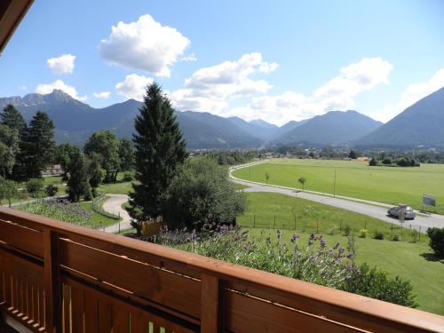 a balcony with a view of a road and mountains at Haus Sonnblick in Wangle